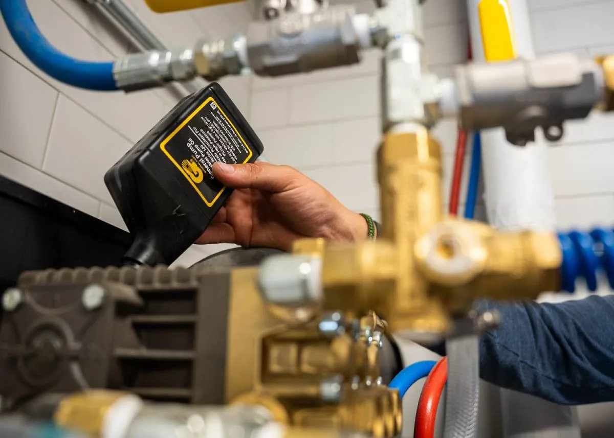 Easiwash technician servicing a customer's pressure washing system